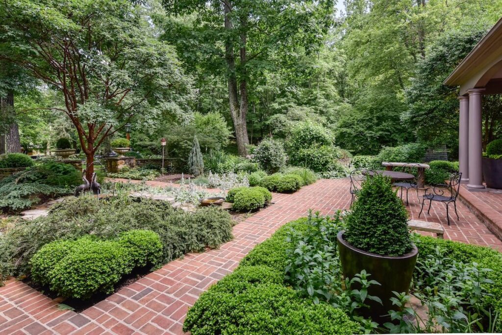 Brick Courtyard Patio with Lush Landscape Plantings