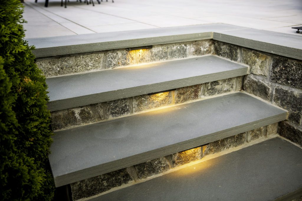 Custom Stone Steps to Elevated Paver Patio Step Riser Lighting