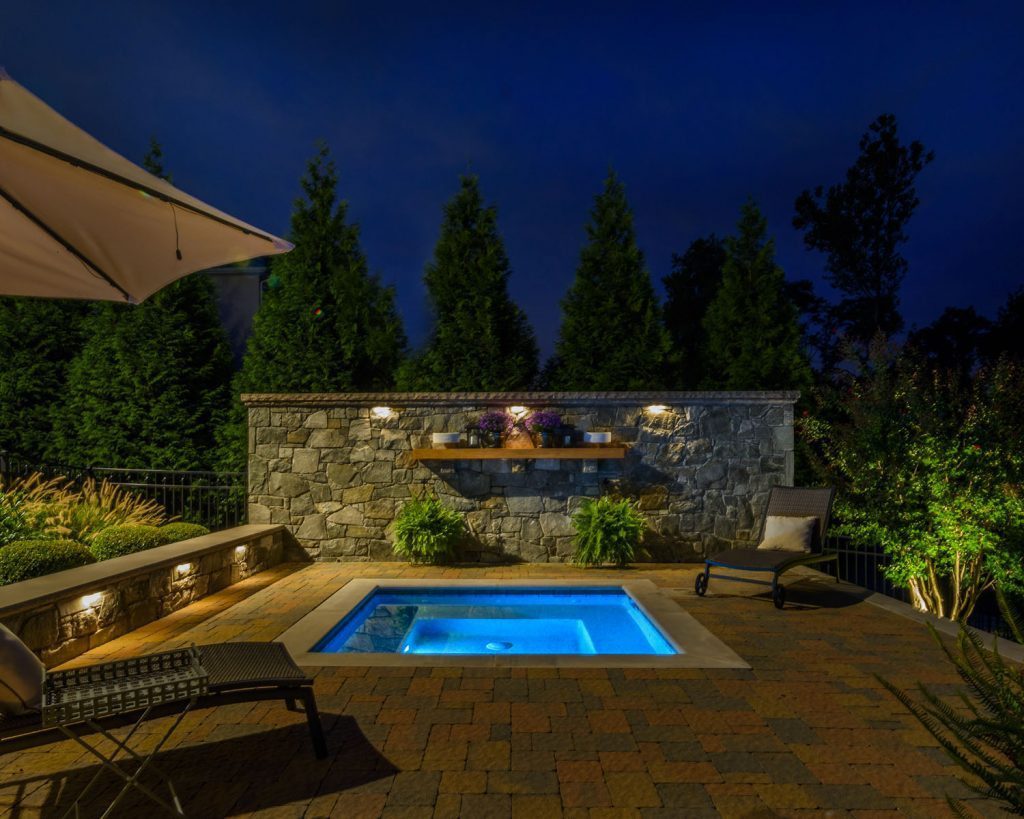 Custom Inground Spa Paver Pool Deck Stone Seat Wall and Stone Accent Wall Landscape Lighting Landscape Plantings
