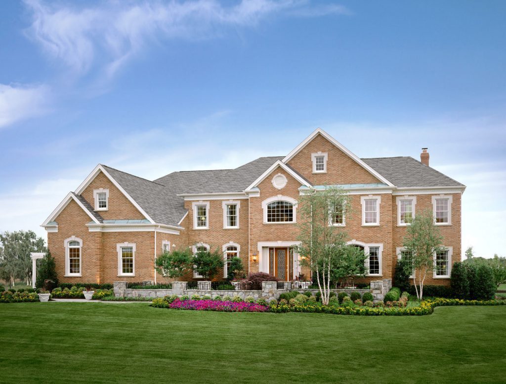 Landscape Plantings with Seasonal Flowers Turf Maintenance Stone Courtyard Walls and Piers with Iron Railing