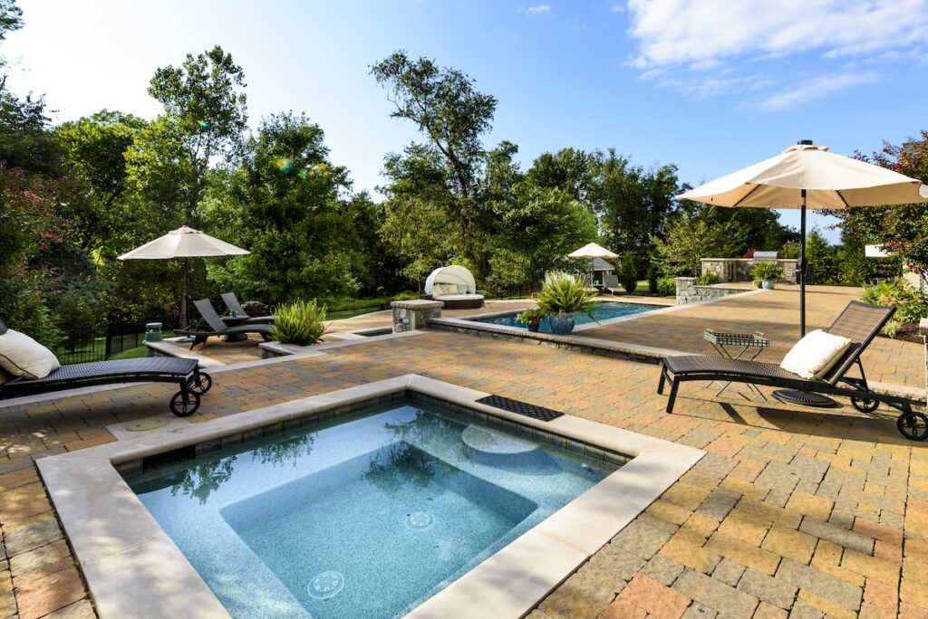 swimming pool and spa with paver pool deck