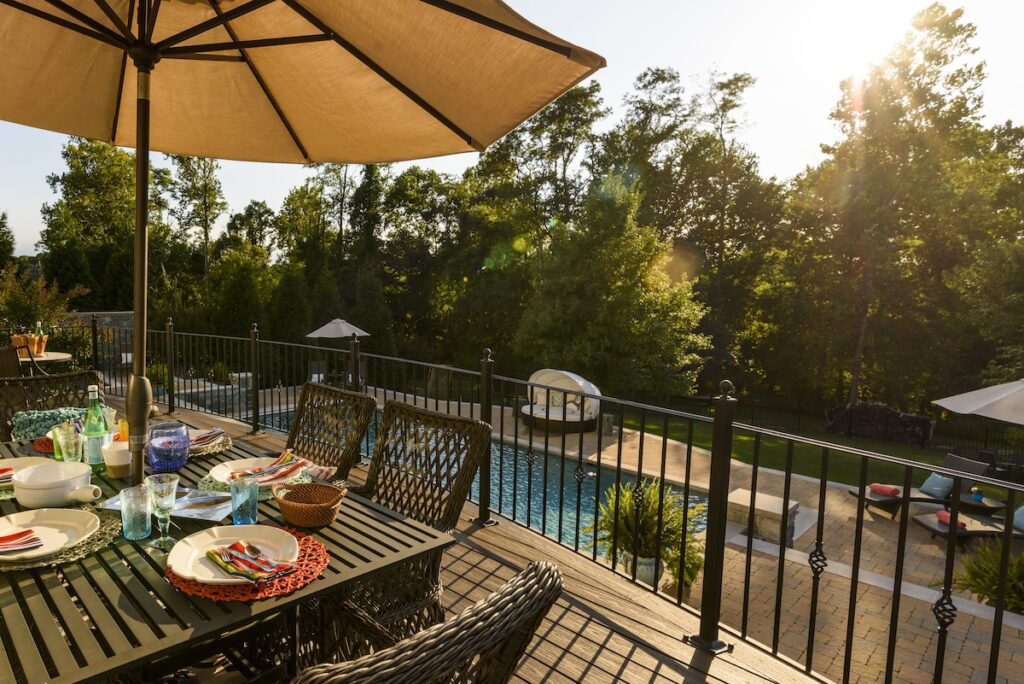 custom composite deck overlooking swimming pool in rear yard