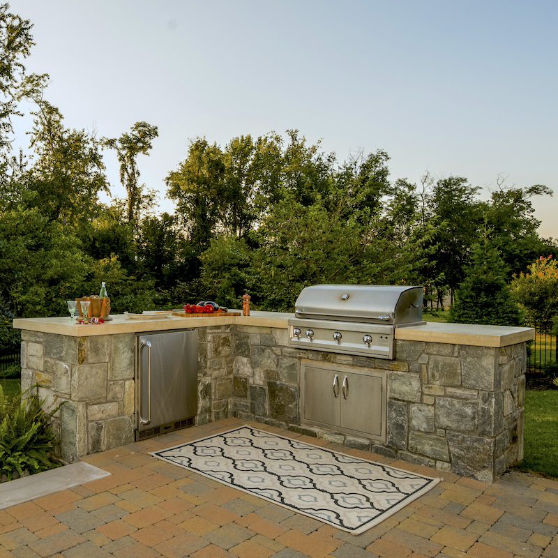 stone outdoor kitchen and bbq with concrete countertops