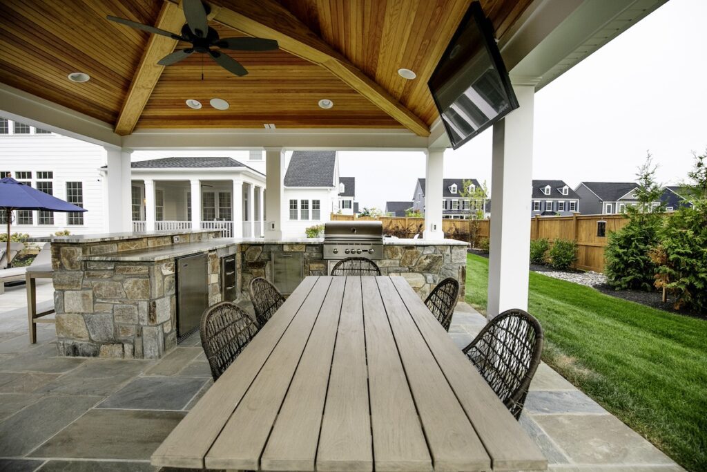 outdoor kitchen and bar seating inside of pavilion