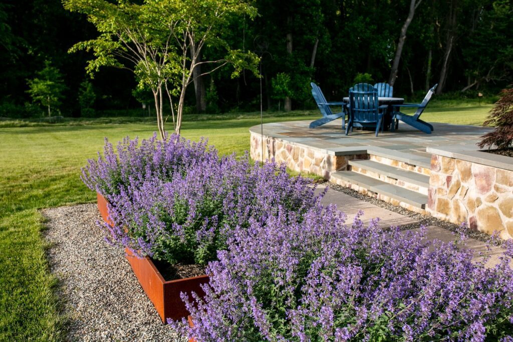 elevated fire pit patio with stone walls and steps Corten steel garden planters