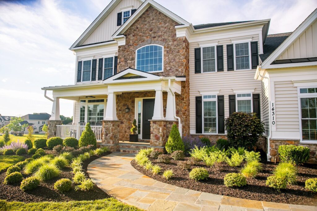 landscape plantings beds in front of house with a flagstone walkway