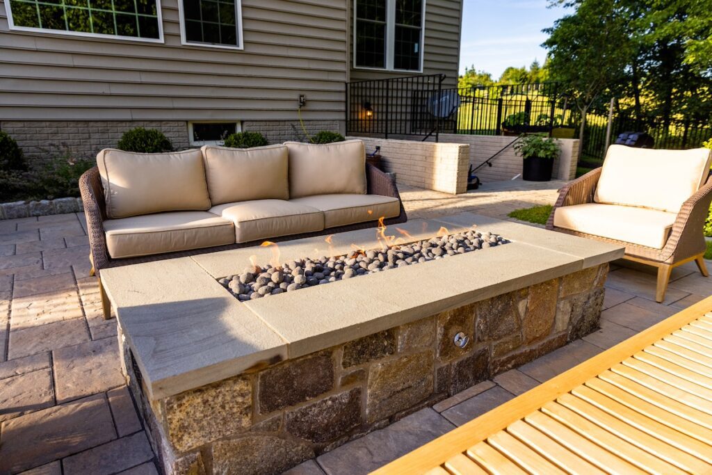 linear stone fire pit with lava rock media
