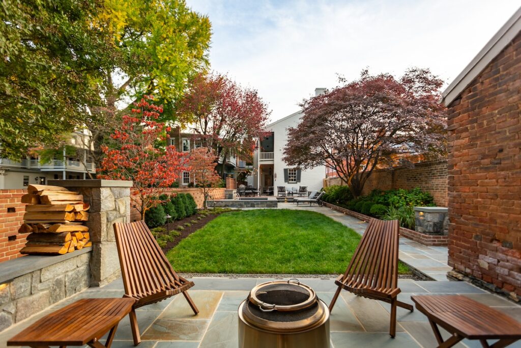 rear yard with custom elevated stone spa and patios