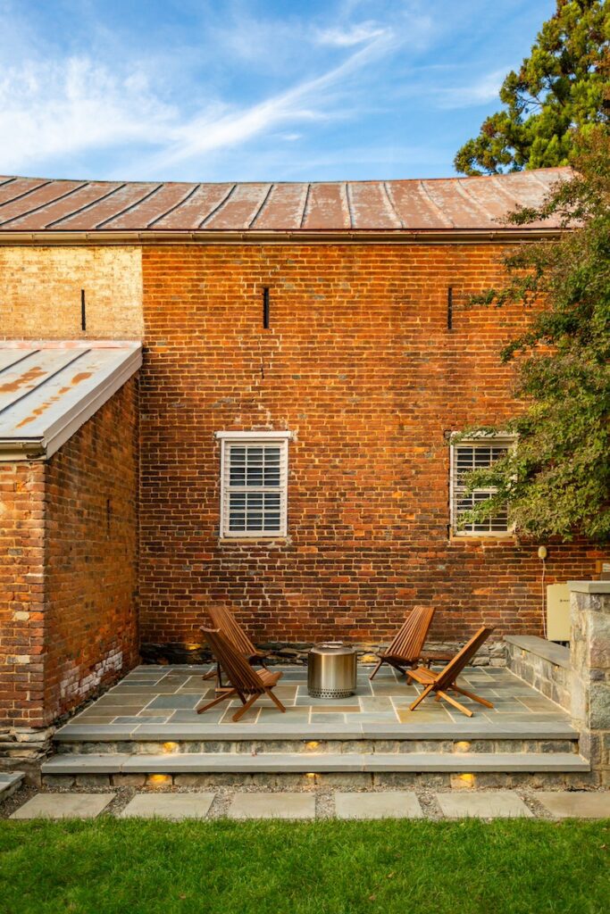 rear yard with custom elevated stone patio