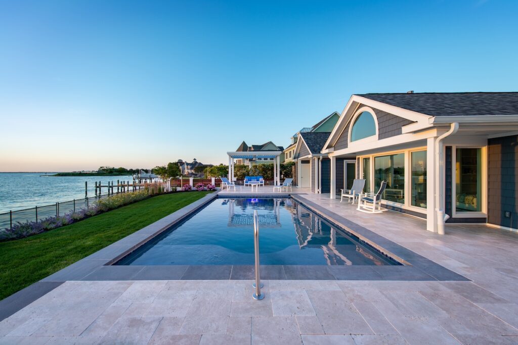 swimming pool with travertine pool deck