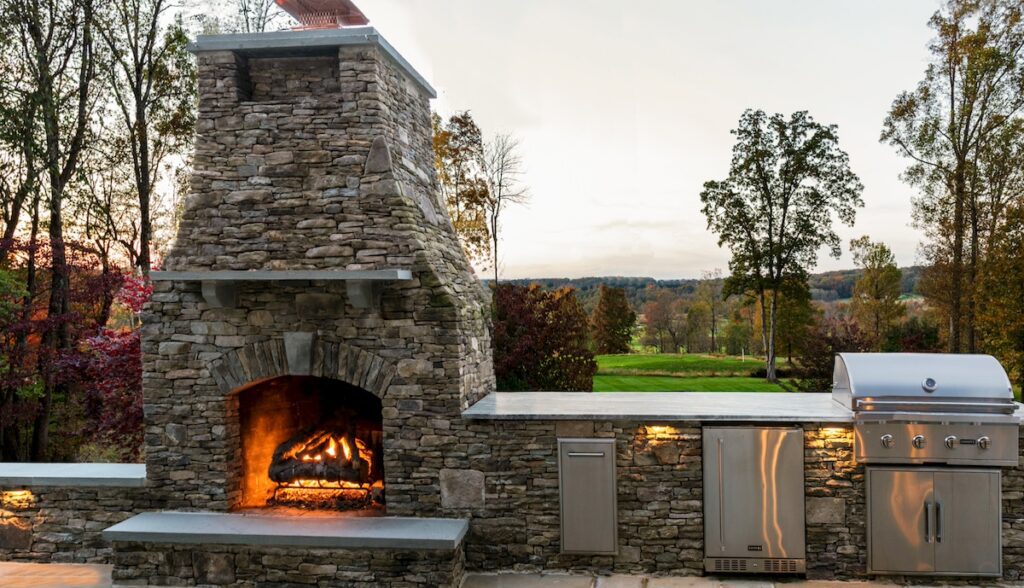 outdoor stone fireplace and kitchen combo