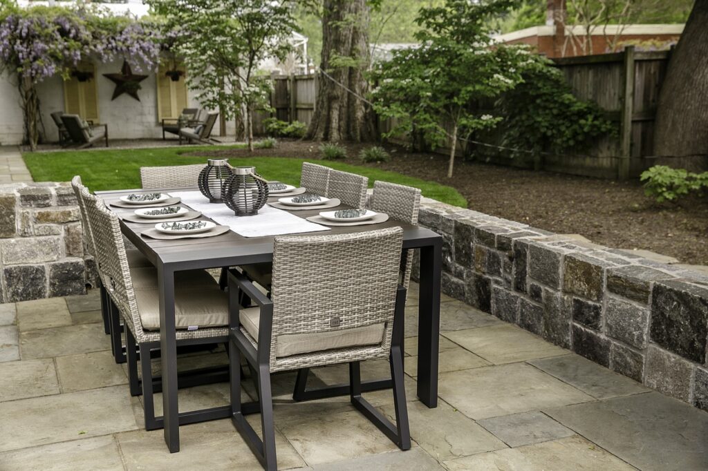 Outdoor dining area in backyard with landscape plantings Stone Seat Walls Flagstone Patio and Walkway