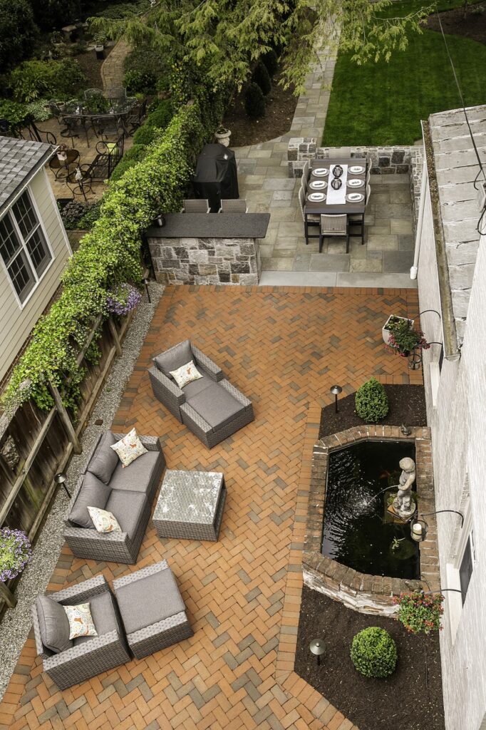 Clay Brick Patio in backyard with custom water feature Bar Seating