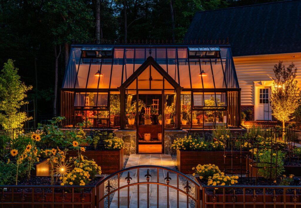 Backyard garden project with Hartley Botanic Glass Greenhouse and raised Corten steel garden planters. Landscape Plantings Low Voltage Lighting Flagstone Walkway