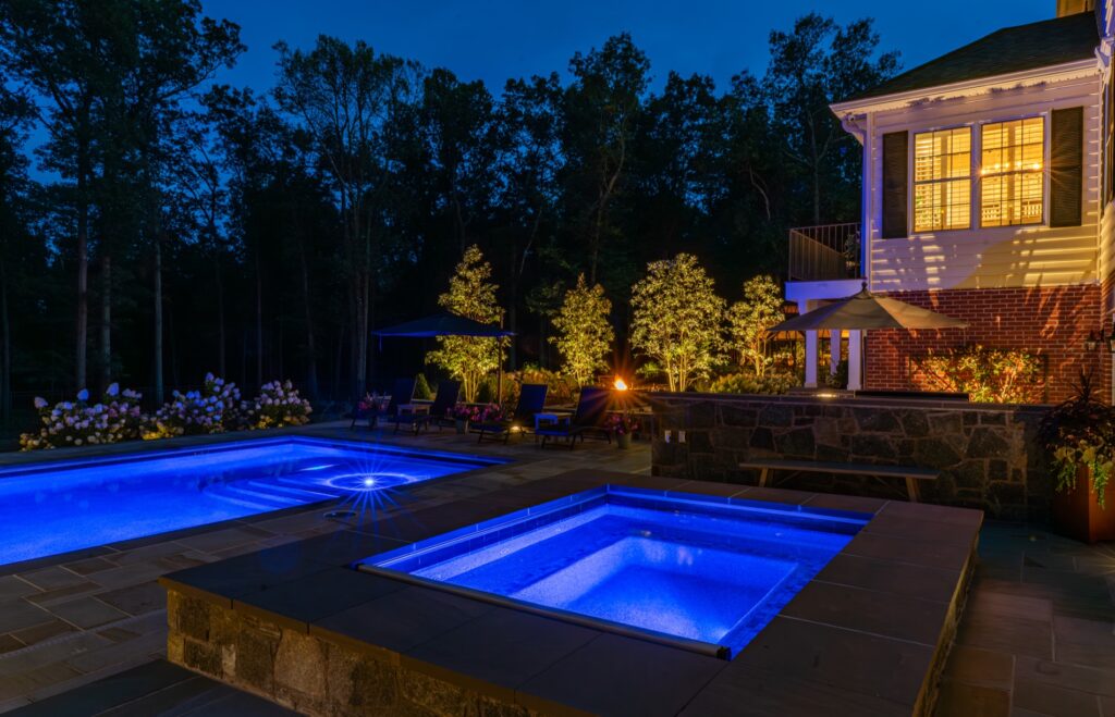 Backyard with custom swimming pool and spa Flagstone Patios Stone Retaining Walls Landscape Plantings Landscape Lighting