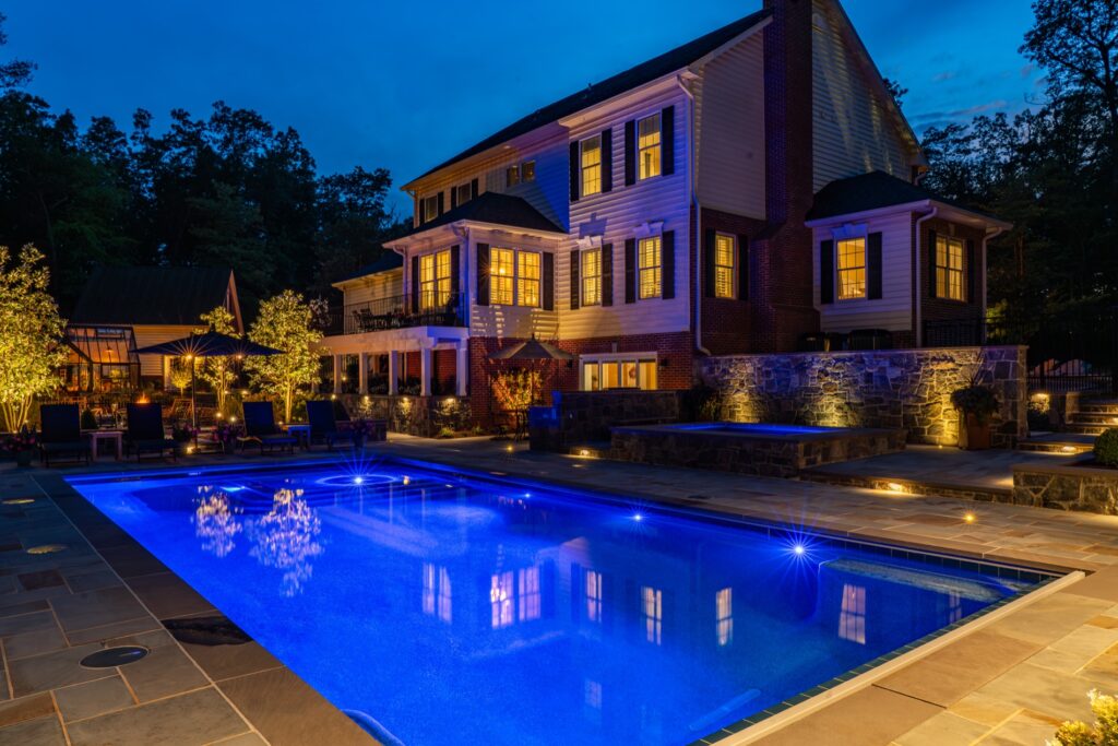 Backyard with custom swimming pool and spa Flagstone Patios Stone Retaining Walls Landscape Plantings Low Voltage Landscape Lighting