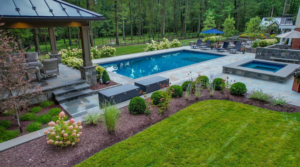 Custom Swimming Pool and Spa with a flagstone pool deck Pool Pavilion Turf Maintenance Landscape Plantings