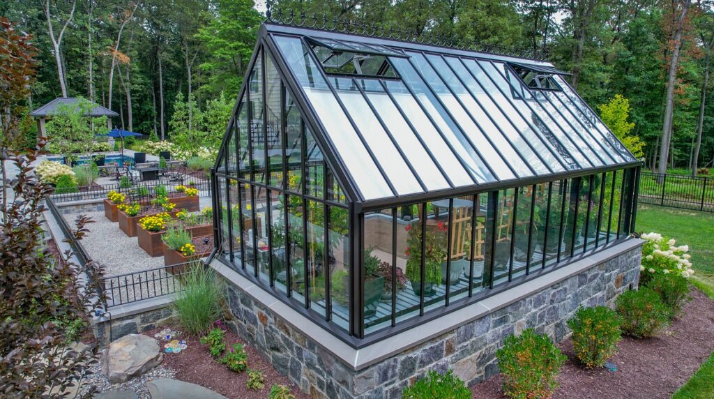 Hartley Botanic Glass Greenhouse with a stone foundation