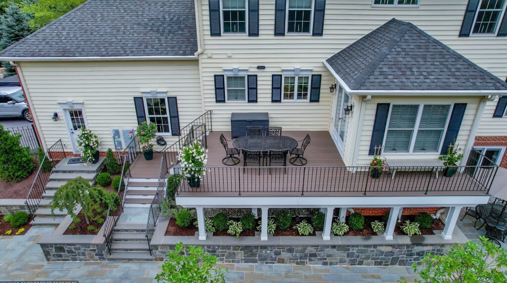 Custom Composite Deck with Steps Stone Retaining Walls and Stone Steps
