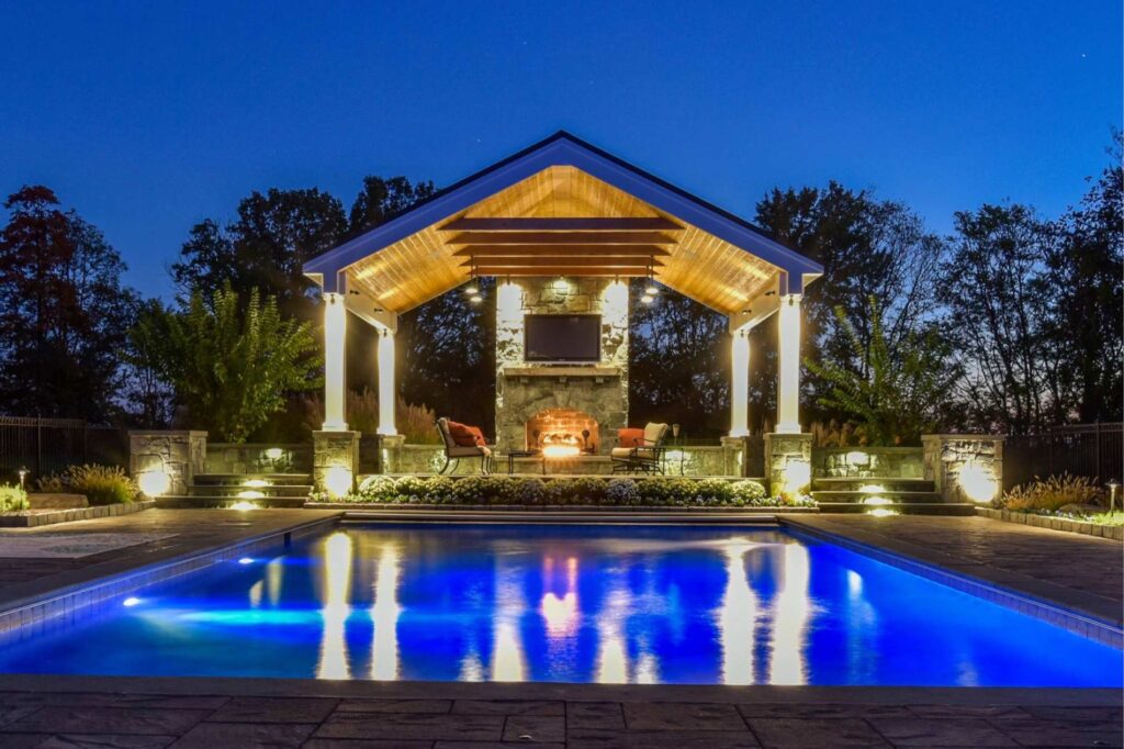 swimming pool with custom pool pavilion natural stone woodburning fireplace