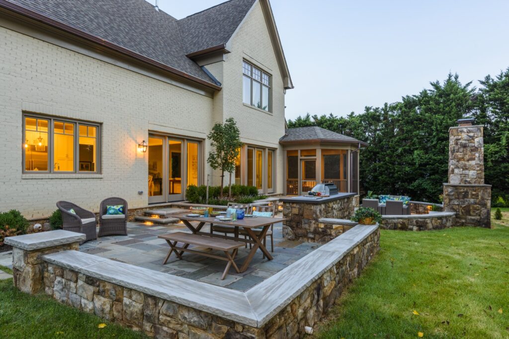 screened porch and bbq kitchen patio with stone steps stone fireplace and seat walls flagstone patio