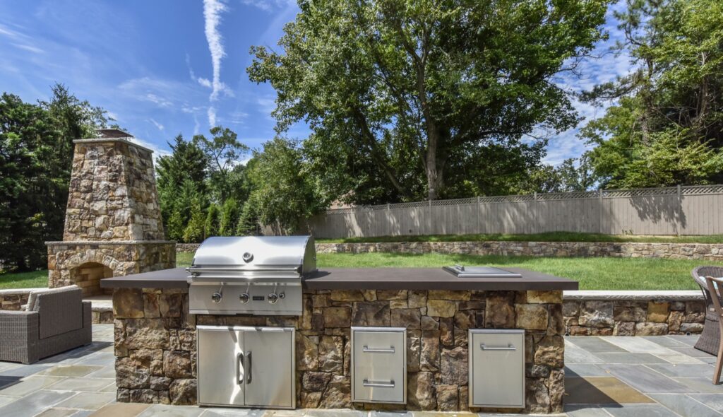 stone outdoor kitchen with concrete countertop