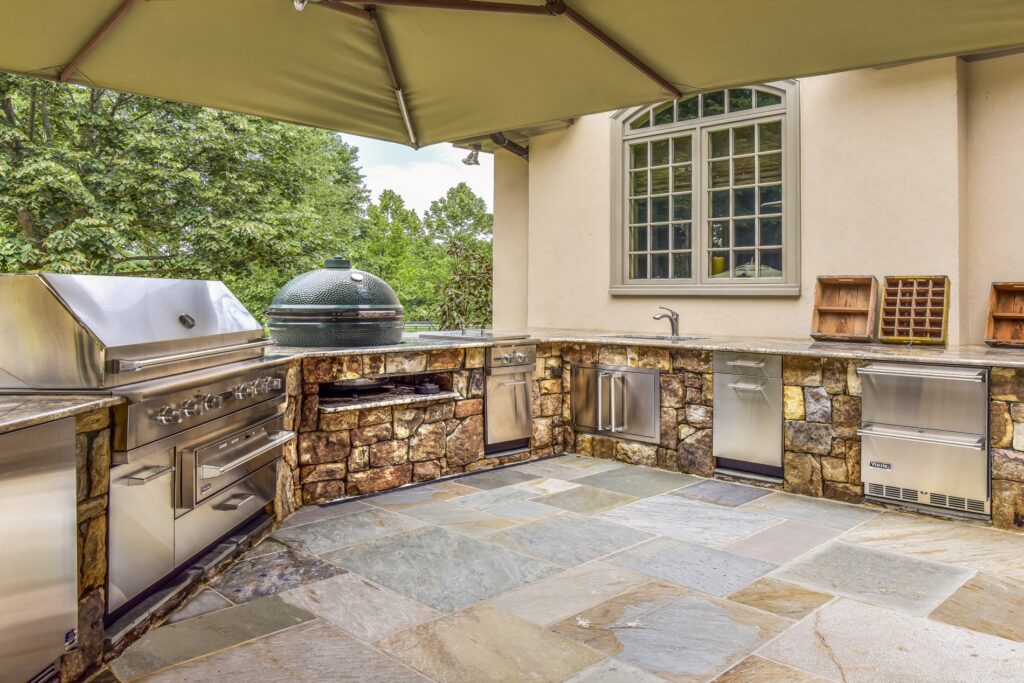 stone outdoor kitchen with big green egg