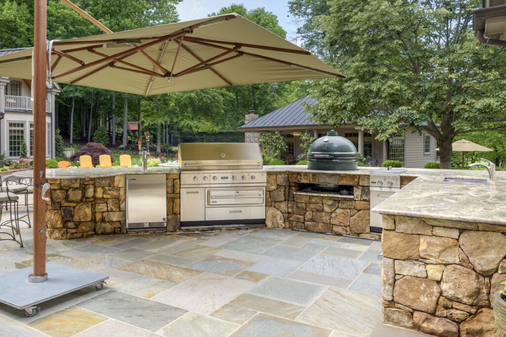 stone outdoor kitchen with big green egg