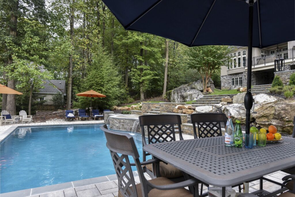 Clearwater Landscape and Nursery swimming pool and large boulders swimming pool and patio with dining area