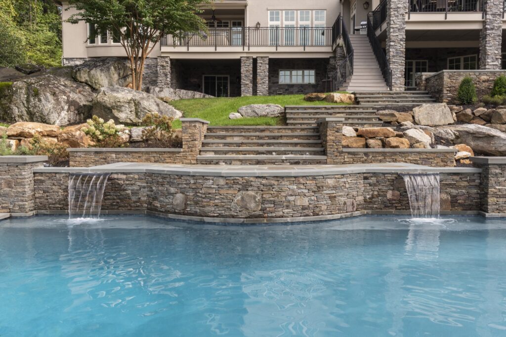 stone walls and waterfalls into swimming pool