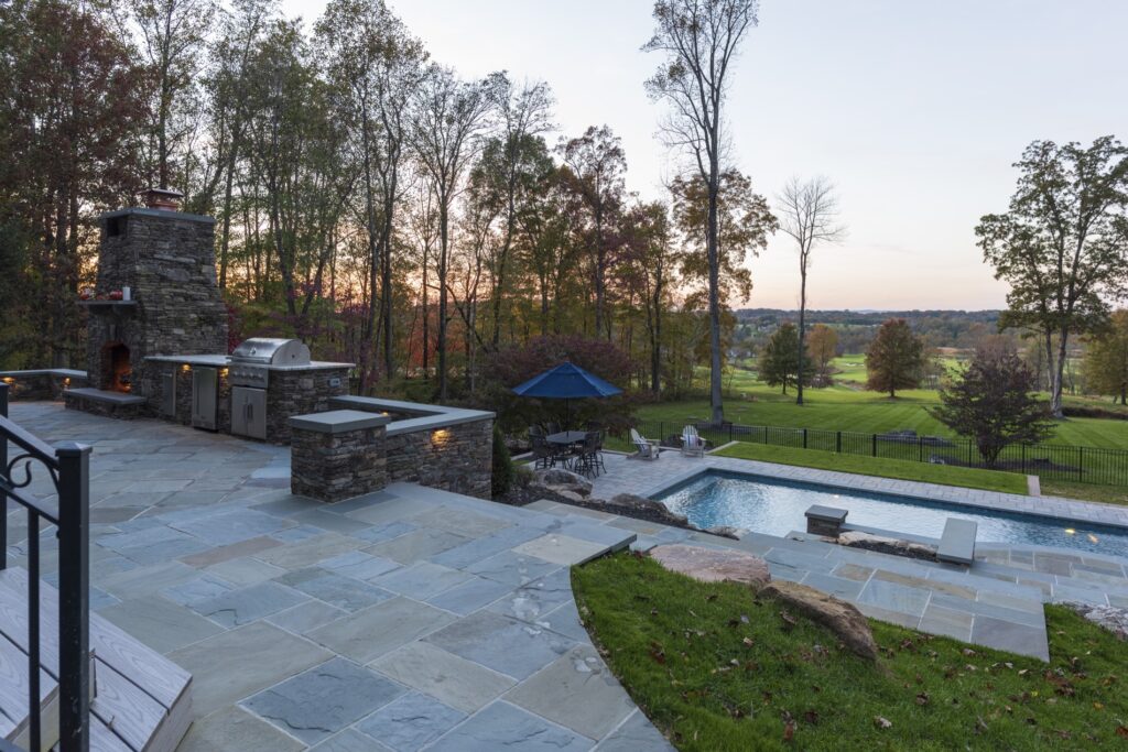 outdoor stone fireplace and BBQ kitchen on patio