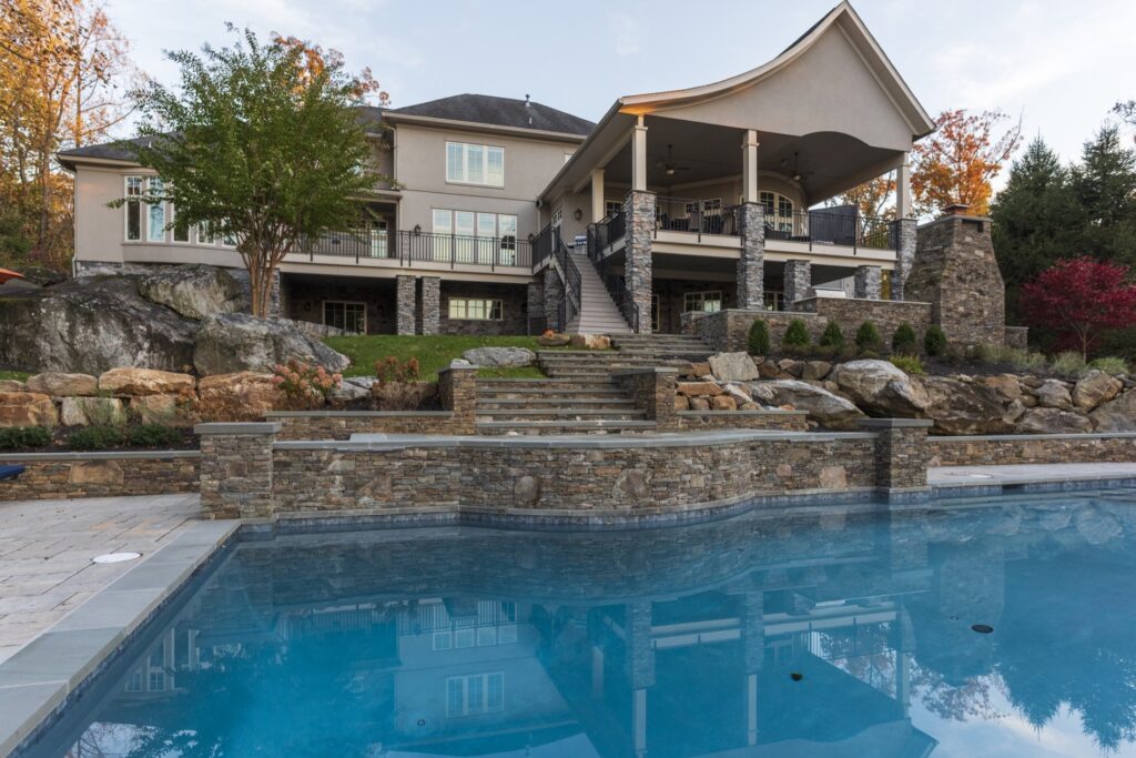 Swimming pool in backyard with paver pool deck flagstone walkway and stone steps Landscape Plantings